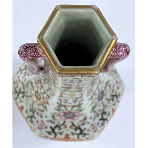435 - A Chinese porcelain vase of hexagonal baluster form with loop handles, stylised floral decoration wi... 