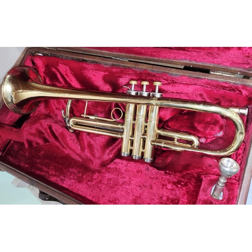 220 - An American Conn cased brass trumpet with mother of pearl inlaid buttons No. K96203