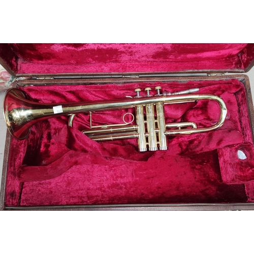 220 - An American Conn cased brass trumpet with mother of pearl inlaid buttons No. K96203