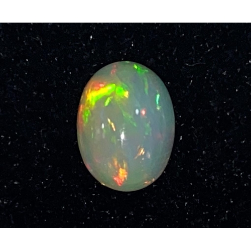 717B - An oval cabochon cut opal, 0.87 carat