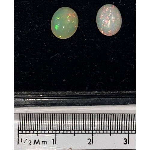 718 - Two cabochon cut opals, 2.2 carats