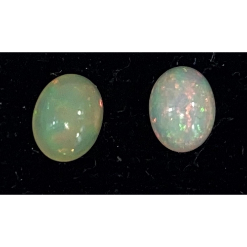 718 - Two cabochon cut opals, 2.2 carats