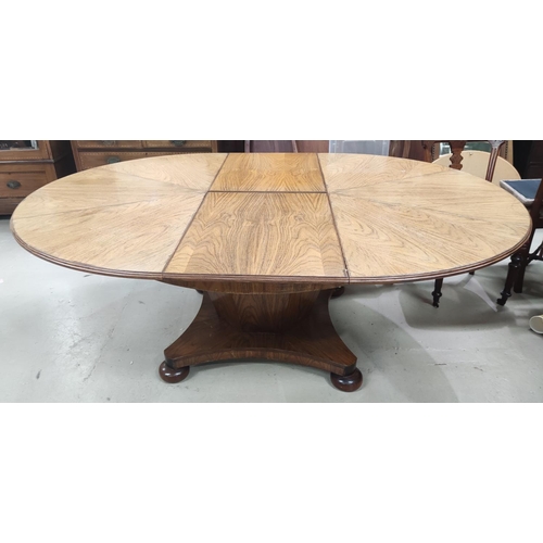 956 - A mid 20th century oriental hardwood dining suite, comprising: a circular extending dining table on ... 