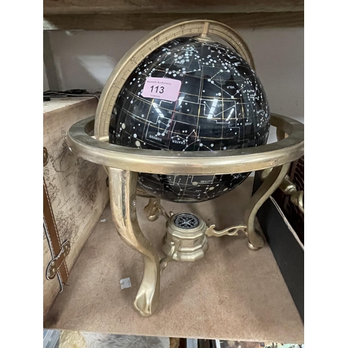 113 - A globe of the night sky and star signs; brass candlesticks, book ends etc.