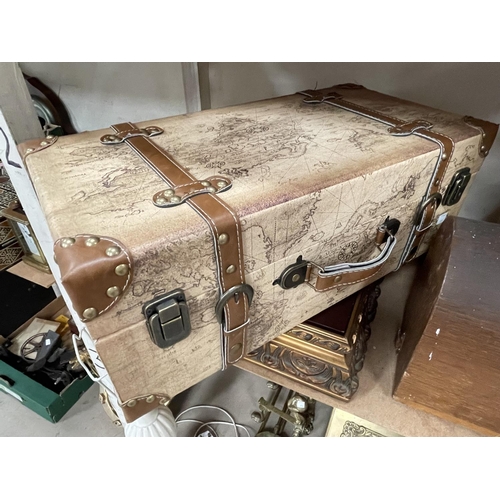 115 - A vintage Grain sewing machine, a small suitcase, a carved wooden figure, a gilt framed map.