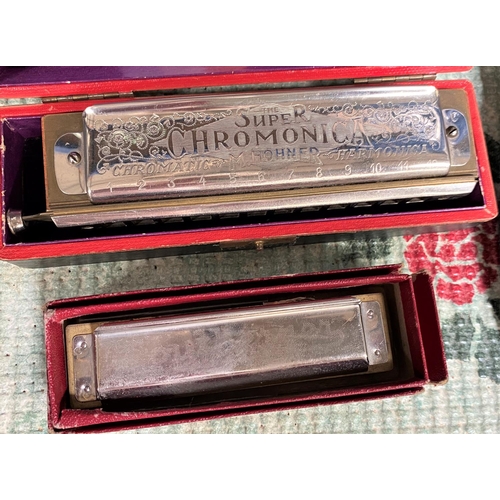 33A - A harmonica Horner Super Chromonica; smaller harmonica and a vintage boatman's cap