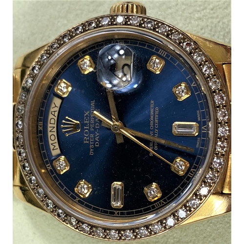 715 - A Rolex 18ct day-date Oyster perpetual with day-date apertures, blue dial bezel and hours set with d... 