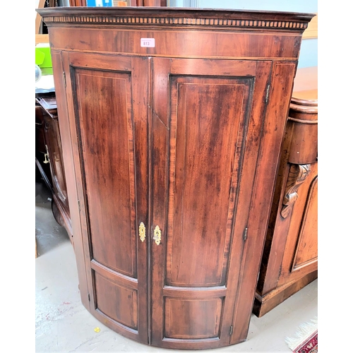 813 - A Georgian inlaid mahogany corner cupboard with bow front enclosed by 2 doors