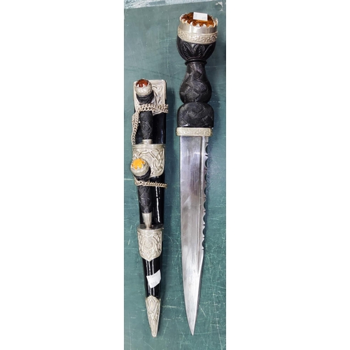 306 - A Scottish Highland pattern dirk with knife and fork simulated cairngorm finials, 39cm overall