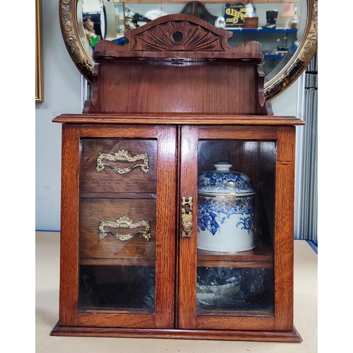 36A - Late 19th/early 20th century smoking cabinet with tobacco jar, glazed doors and pipe rack above