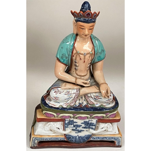 450E - A Chinese ceramic figure of a Buddha in seated lotus position with hole to back possibly for wall ha... 