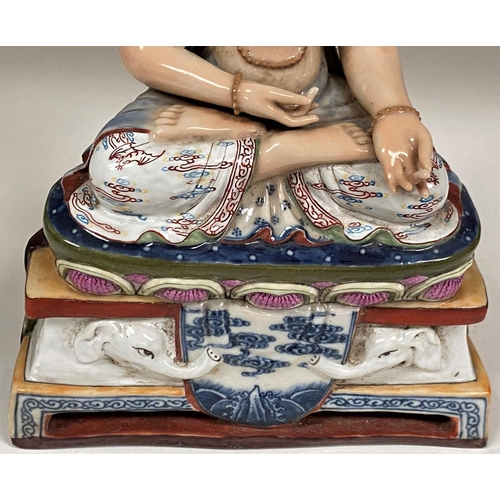 450E - A Chinese ceramic figure of a Buddha in seated lotus position with hole to back possibly for wall ha... 