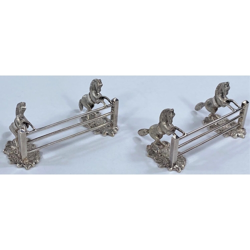 683B - A pair of plated knife rests in the form of fence jumping horses.