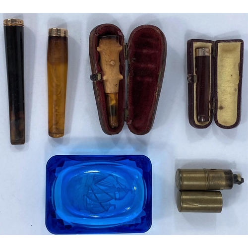 690 - A selection of gold banded cigarette/cheroot holder; lighters etc.