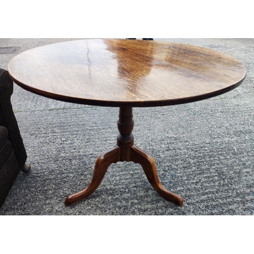 920 - A 19th century oak tilt top occasional table on pedestal with three splay feet