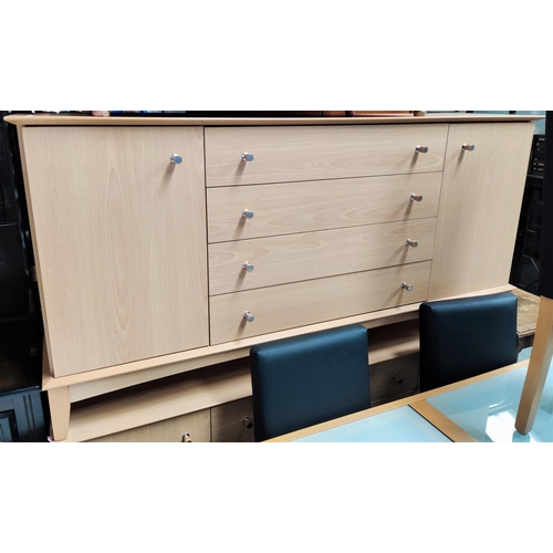 927 - A modern light wood effect sideboard by Beautility with double cupboard and four central drawers, le... 