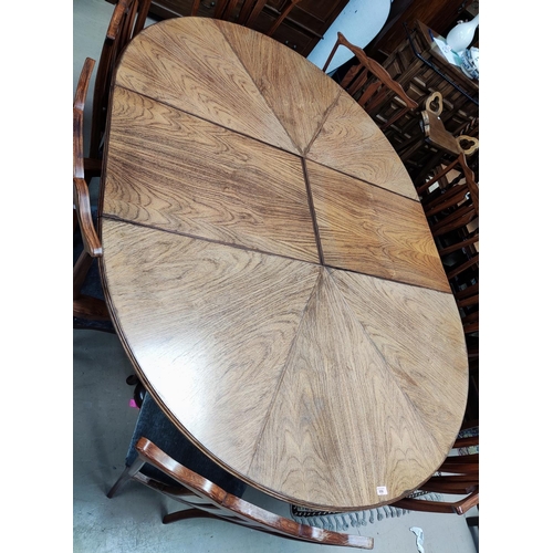 956 - A mid 20th century oriental hardwood dining suite, comprising: a circular extending dining table on ... 