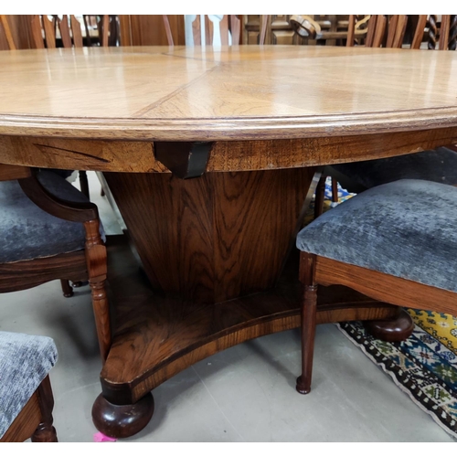 956 - A mid 20th century oriental hardwood dining suite, comprising: a circular extending dining table on ... 