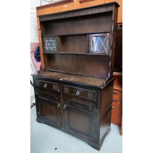 957 - A reproduction dark oak Welsh Dresser with glassed cupboards and shelves, over two cupboards and dra... 