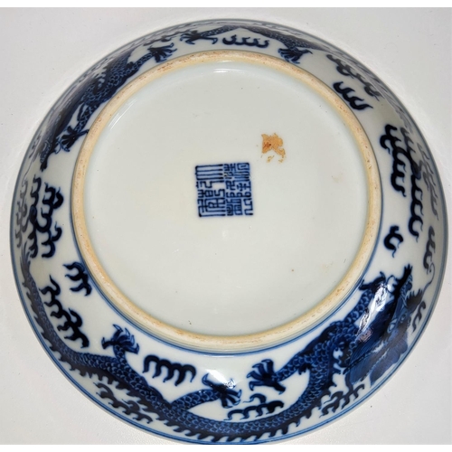 426 - A Chinese blue and white dish with central dragon to inside and around the rim with seal mark to bas... 