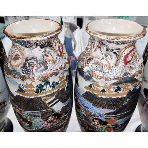 463 - A pair of Japanese Satsuma vases decorated with Samurai on horseback (chips to feet and dragon); a l... 