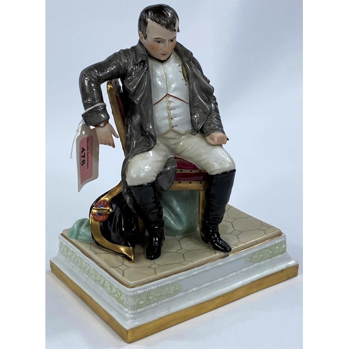 478 - NAPOLEON BONAPARTE, a continental porcelain figure with Napoleon seated, 24cm