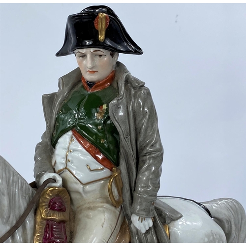 479 - NAPOLEON BONAPARTE, A continental porcelain figure with Napoleon on horseback, 33cm (chip to hand)
