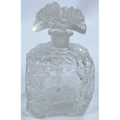 480 - A 1930's continental moulded glass scent bottle decorated with flowers, 13cm and a similar fruit bow... 