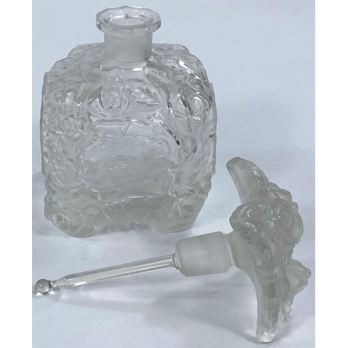 480 - A 1930's continental moulded glass scent bottle decorated with flowers, 13cm and a similar fruit bow... 