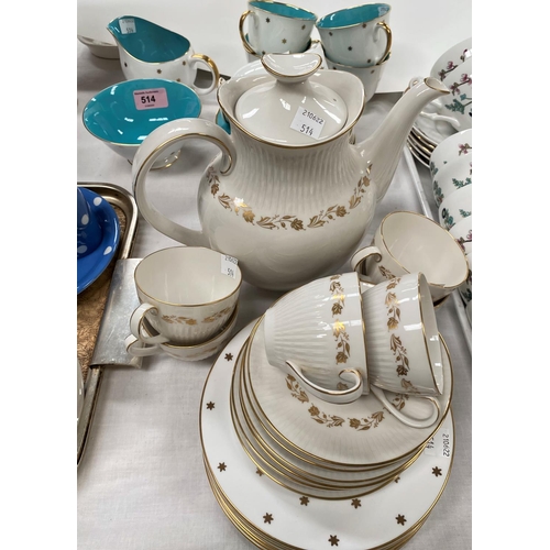 514 - A Susie Cooper part tea service gilt stars turquoise interior, 6 cups and saucers, milk jug and bowl... 