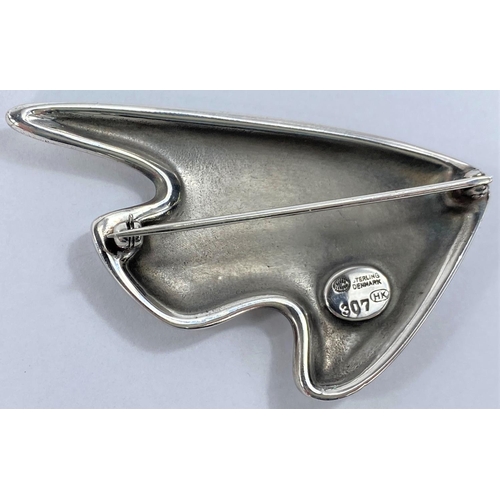 586 - Georg Jensen:  a silver brooch in the form of a stylized fish in varying shades of purple ename... 