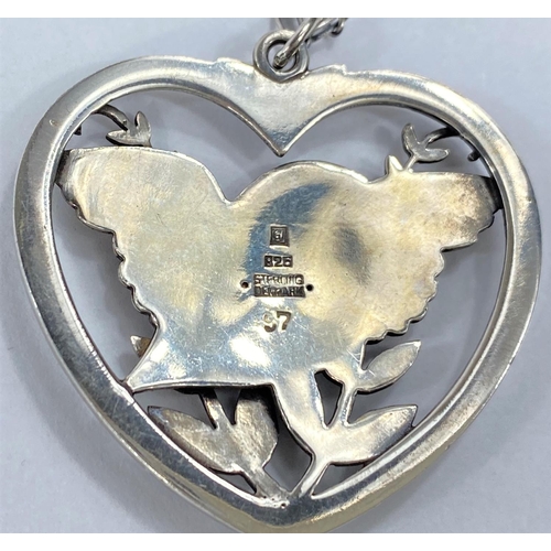 587 - Georg Jensen:  a silver pendant/necklace, the pierced heart shaped drop with bird, wings outstr... 