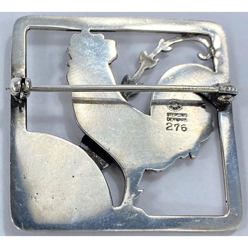 590 - Georg Jensen:  a silver square pierced brooch with cockerel in foliage, designed by Arno Malino... 