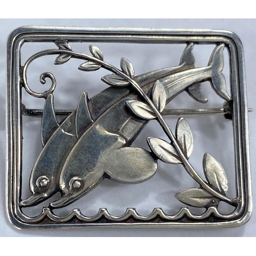 592 - Georg Jensen:  a silver pierced rectangular brooch with twin leaping dolphins and diagonal frond, de... 