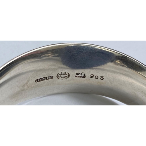 597 - Georg Jensen:  a silver bangle designed by Vivianna Torun Bülow-Hübe, the swivel top set oval polish... 