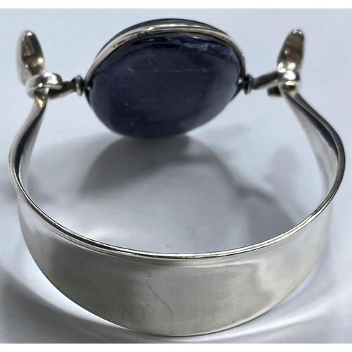 597 - Georg Jensen:  a silver bangle designed by Vivianna Torun Bülow-Hübe, the swivel top set oval polish... 