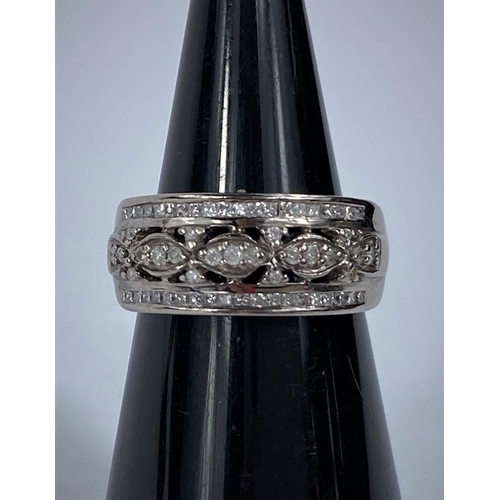 631 - A 9 carat hallmarked white gold dress ring with multiple diamonds in intricate setting, 5 gm, size N