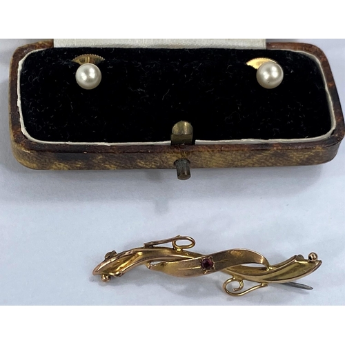 638 - A pair of yellow metal and seed pearl cufflinks stamped 925 and a yellow metal brooch with central r... 