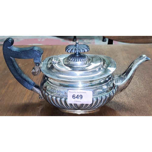 649 - A hallmarked silver batchelor's tea pot with ebonised handle, ribbed body, Sheffield 1912, 14oz