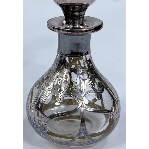 659 - A spherical cut glass scent bottle with silver mount and an overlaid similar 