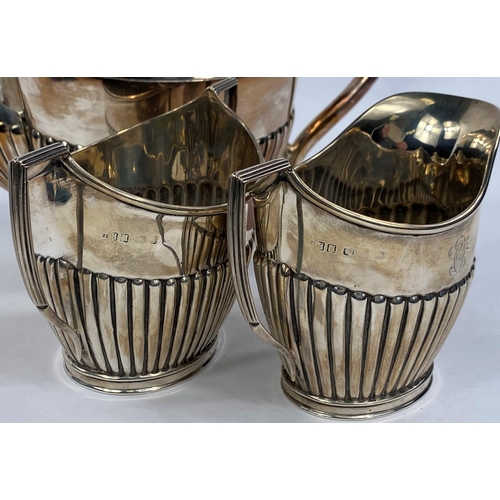 696 - A two piece set of silver milk jug and sugar bowl monogrammed with ribbed decoration, marks rubbed, ... 