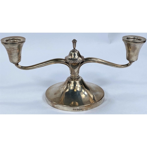 697 - A hallmarked silver, two branched candelabra of squat form, Sheffield 1962, weighted base.We have be... 