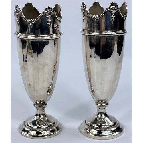 698 - A pair of hallmarked silver vases with weighted bases, tapering form with peaked shell rim, Birmingh... 