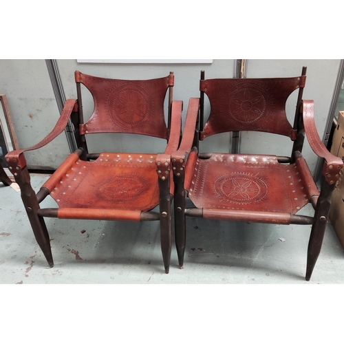 826 - A pair of safari chairs in wood and tan leather with studded incised decoration