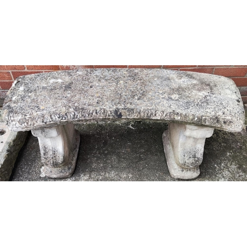 943 - A bowed stone two seater garden bench