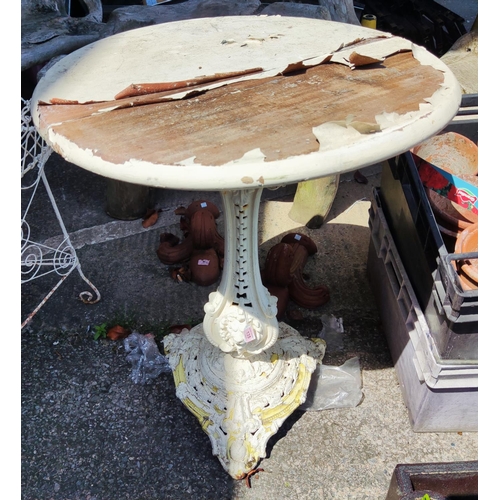 135 - A Victorian cast iron garden table with pierced triform base, distressed mahogany top, 80cm high