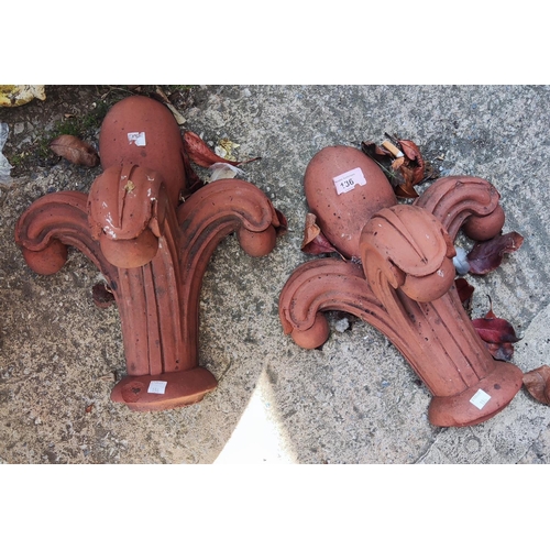 136 - A pair of terracotta fleur-de-lys finials, 36cm