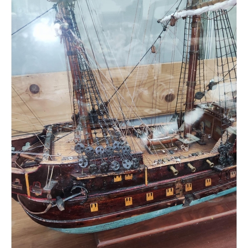 88 - An early 20th century scratch built model of a Man-O-War, fully armed and rigged, 67cm in glazed cas... 