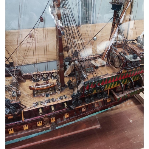 88 - An early 20th century scratch built model of a Man-O-War, fully armed and rigged, 67cm in glazed cas... 
