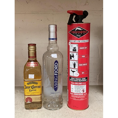 178 - 75 cl of vodka in novelty fire extinguisher metal bottle; a 70 cl bottle of 